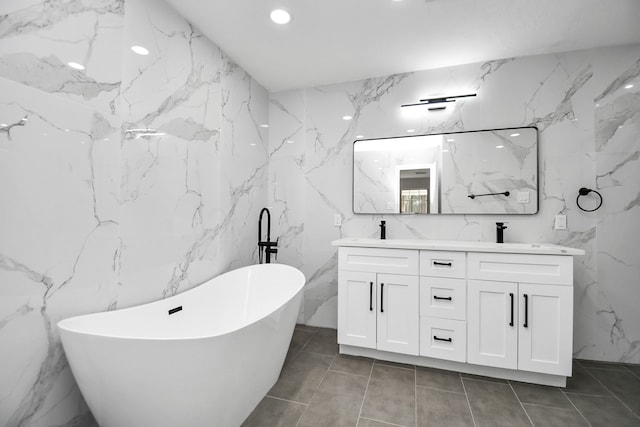 bathroom featuring vanity, a bathtub, and tile walls