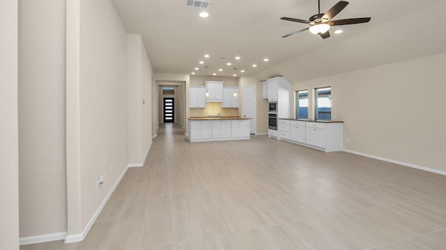 unfurnished living room with ceiling fan