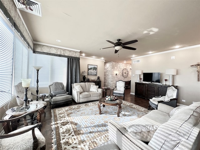 living room featuring dark wood-type flooring, crown molding, and ceiling fan