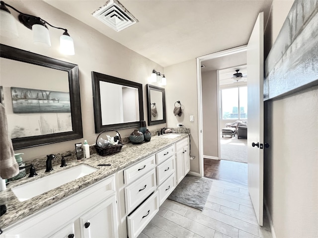 bathroom featuring vanity, hardwood / wood-style floors, and ceiling fan