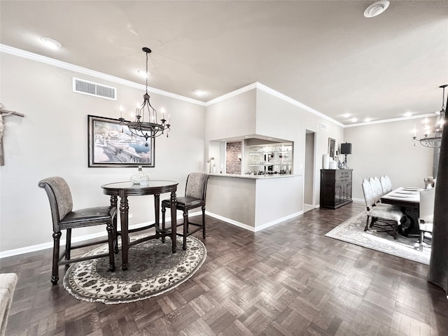 dining room with a chandelier, crown molding, and dark parquet flooring