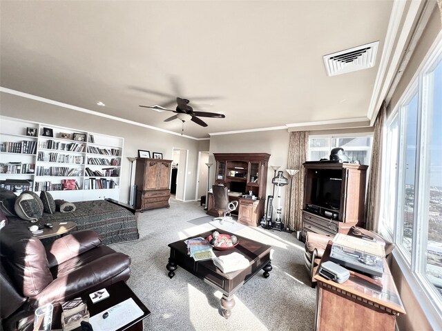 living room featuring crown molding, light carpet, a healthy amount of sunlight, and ceiling fan