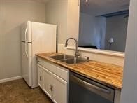 kitchen with sink, dishwasher, white cabinetry, and white refrigerator