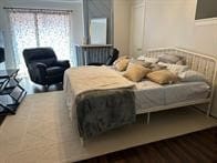 bedroom featuring dark hardwood / wood-style flooring