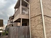 view of side of home featuring a balcony