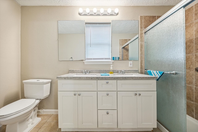 bathroom featuring toilet, tile patterned flooring, vanity, a textured ceiling, and an enclosed shower