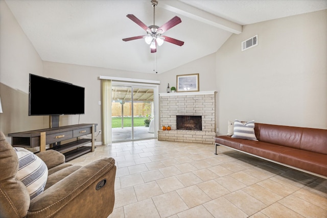 living room with ceiling fan, lofted ceiling with beams, light tile patterned flooring, and a brick fireplace