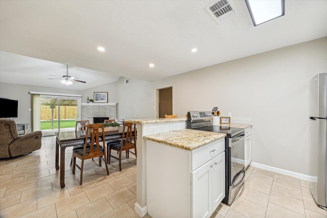 kitchen featuring stainless steel appliances, vaulted ceiling, light tile patterned floors, white cabinets, and ceiling fan