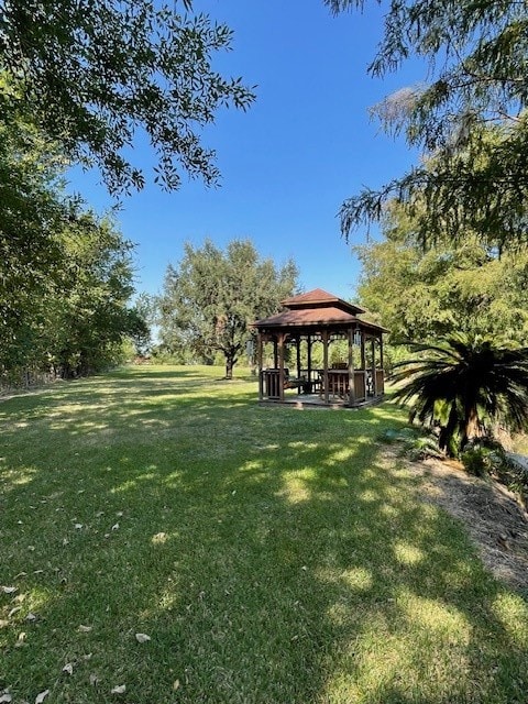 surrounding community with a yard and a gazebo