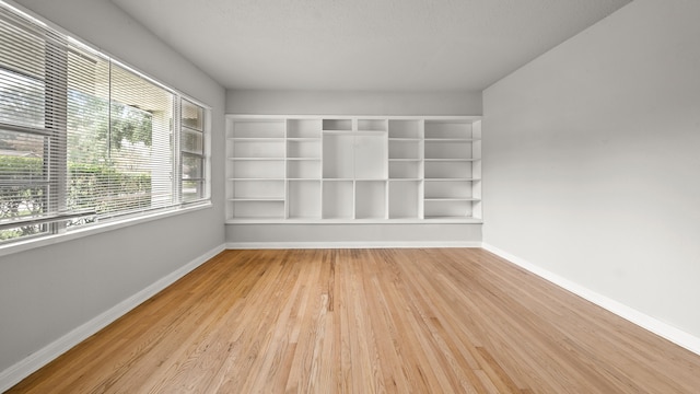 spare room with light hardwood / wood-style flooring