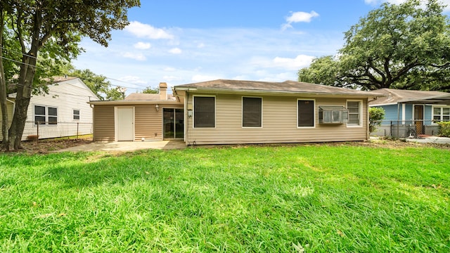 back of property featuring a patio area and a lawn