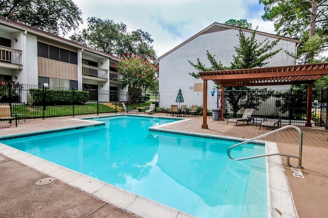 pool with fence and a patio