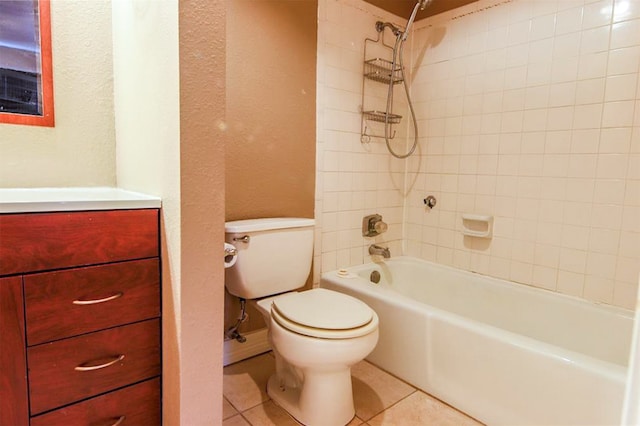 full bathroom featuring vanity, toilet, tiled shower / bath combo, and tile patterned flooring