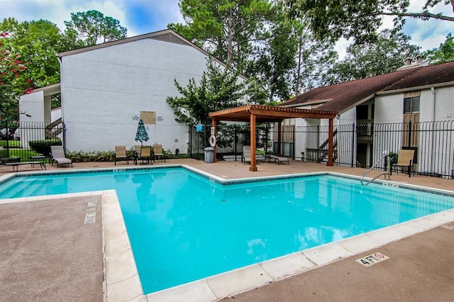 view of swimming pool with a patio and a pergola