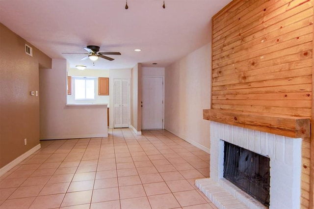 12100 Melville Dr Unit 402D, Montgomery, TX 77356 - unfurnished living room with a ceiling fan, a brick fireplace, baseboards, recessed lighting, and light tile patterned floors