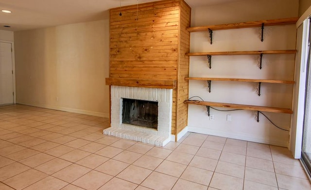 unfurnished living room with light tile patterned flooring and a fireplace