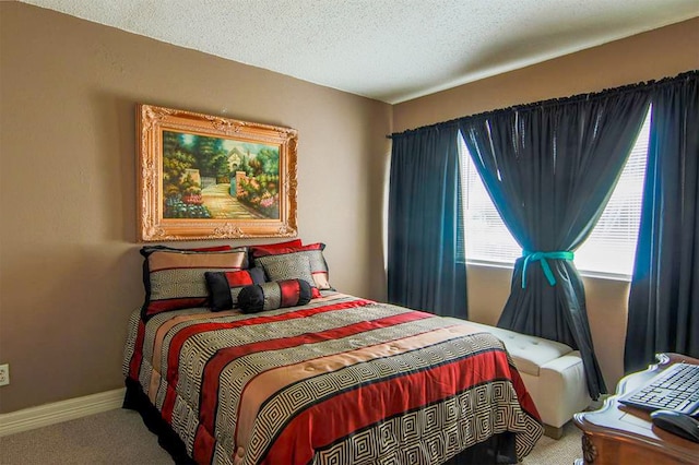 bedroom with a textured ceiling and carpet floors