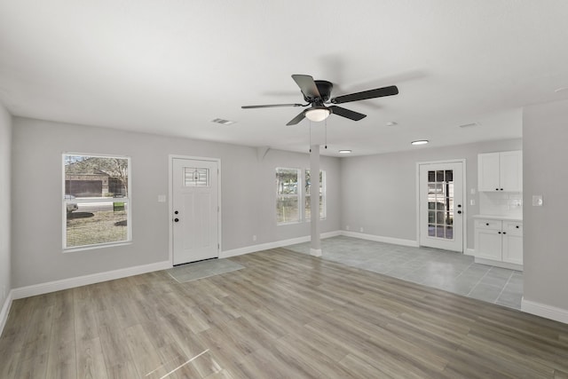 entryway with a healthy amount of sunlight, light wood-type flooring, and ceiling fan