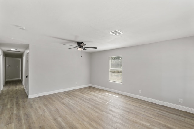 empty room with ceiling fan and light hardwood / wood-style flooring