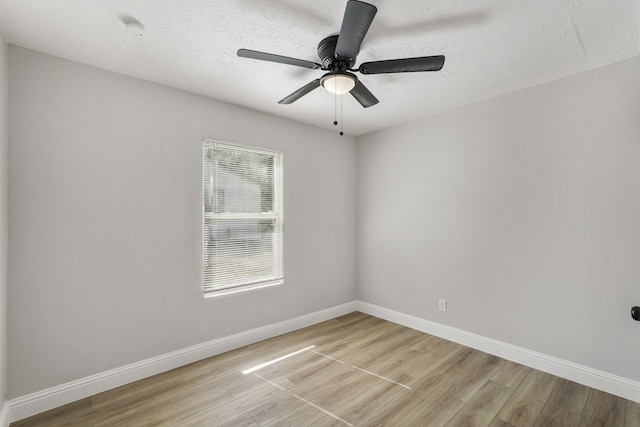 empty room featuring ceiling fan, a textured ceiling, and light wood-type flooring