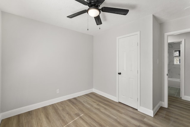 unfurnished bedroom with ceiling fan and light hardwood / wood-style floors