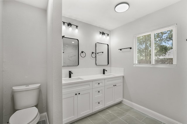 bathroom featuring vanity, toilet, and tile patterned floors