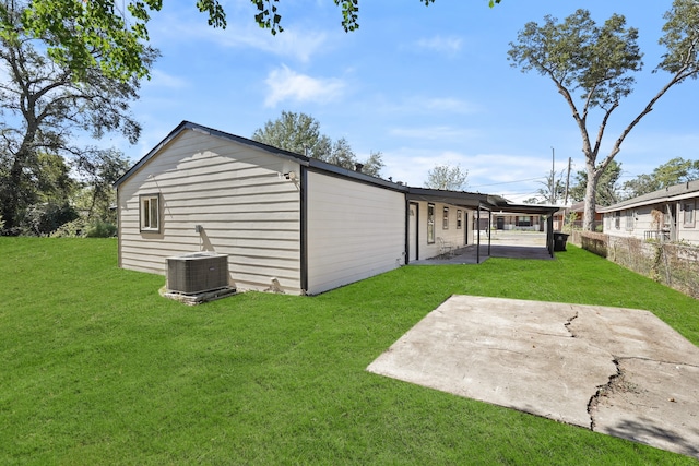 view of outbuilding featuring a yard and central AC