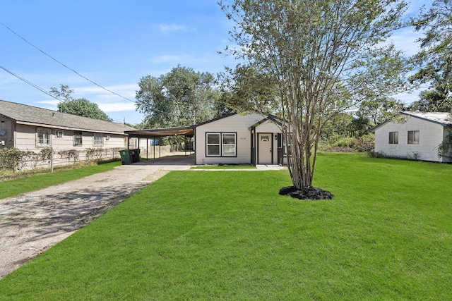 view of front of house featuring a front lawn and a carport