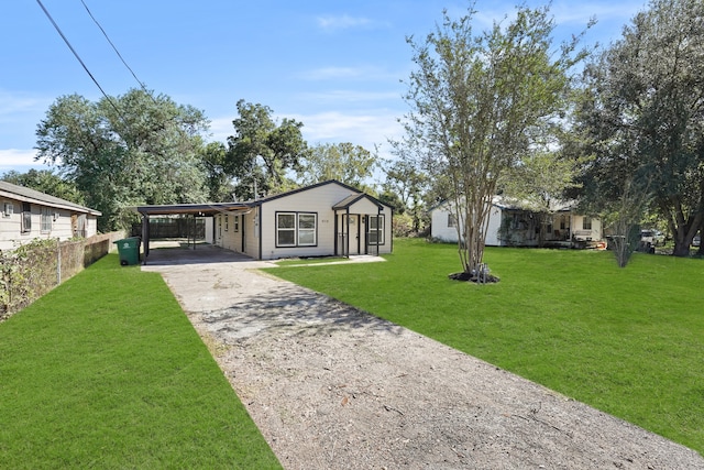 view of front facade with a front yard and a carport