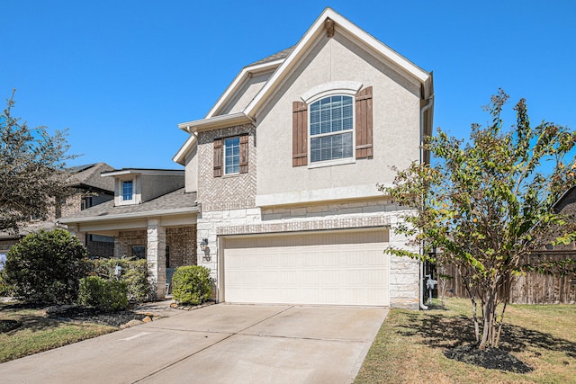 view of front of home featuring a front yard and a garage