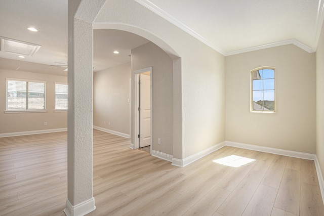 empty room with light hardwood / wood-style floors and crown molding