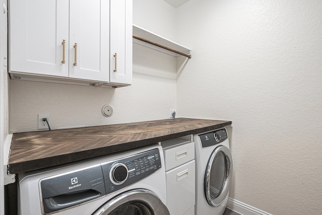 laundry area featuring independent washer and dryer and cabinets