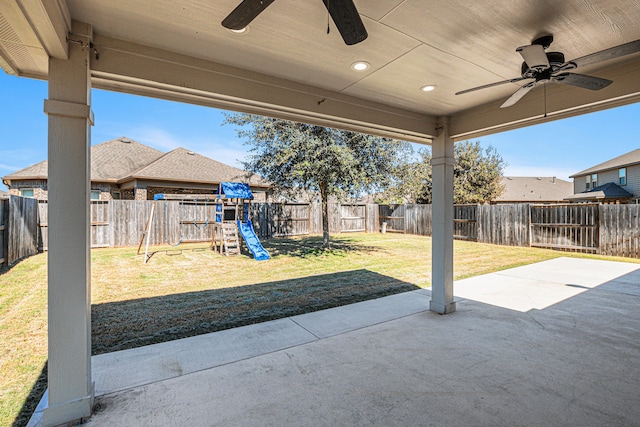 view of patio with ceiling fan and a playground