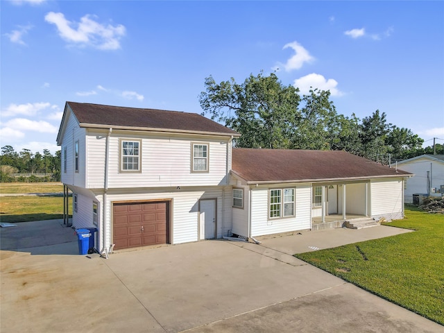 view of front of property with a front yard and a garage