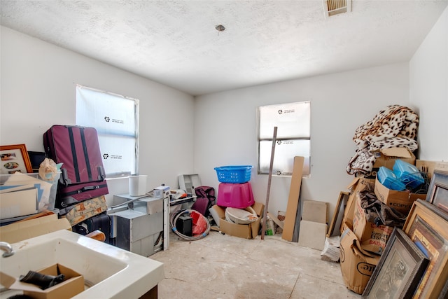 office space with a textured ceiling and sink