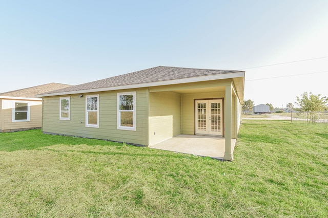 rear view of house featuring a patio and a lawn