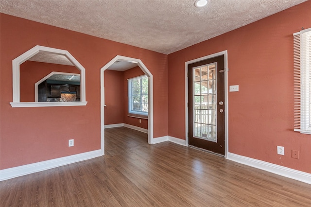 foyer with a textured ceiling and hardwood / wood-style flooring