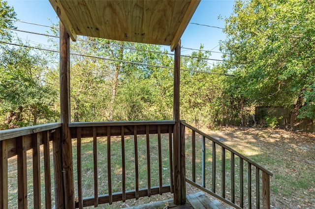 wooden deck with a lawn and fence