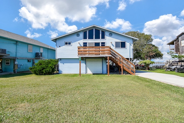 back of property with a yard and a garage