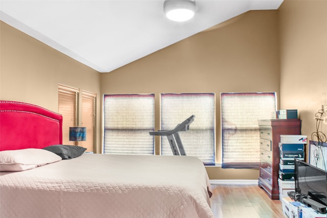 bedroom with lofted ceiling and light hardwood / wood-style flooring