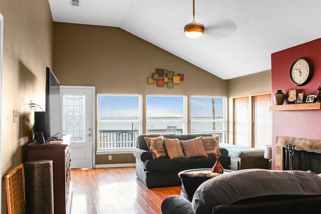 living room with vaulted ceiling, light wood-type flooring, and ceiling fan