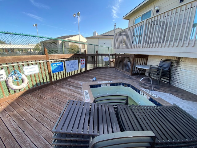 view of pool featuring a jacuzzi and a wooden deck