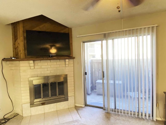 unfurnished living room with a brick fireplace, a textured ceiling, and a wealth of natural light