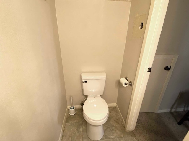 bathroom featuring toilet and tile patterned flooring