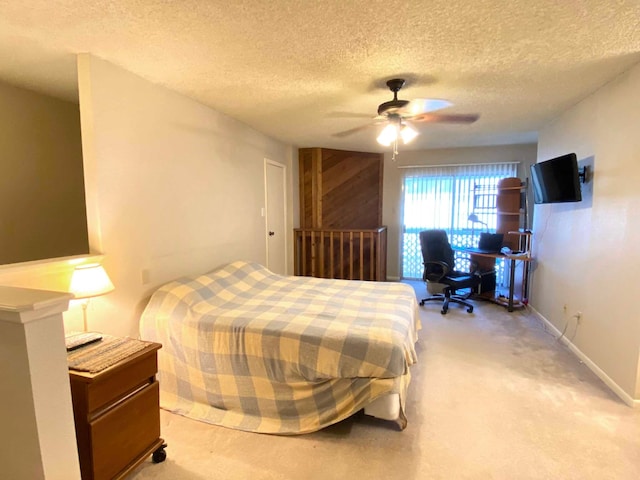 carpeted bedroom with a textured ceiling and ceiling fan