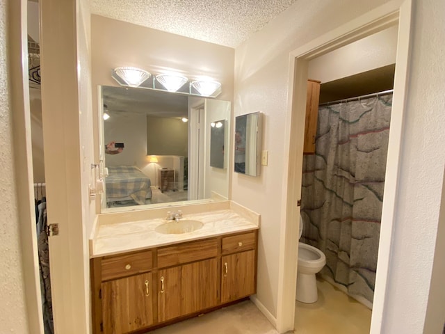 bathroom featuring vanity, toilet, a textured ceiling, and walk in shower