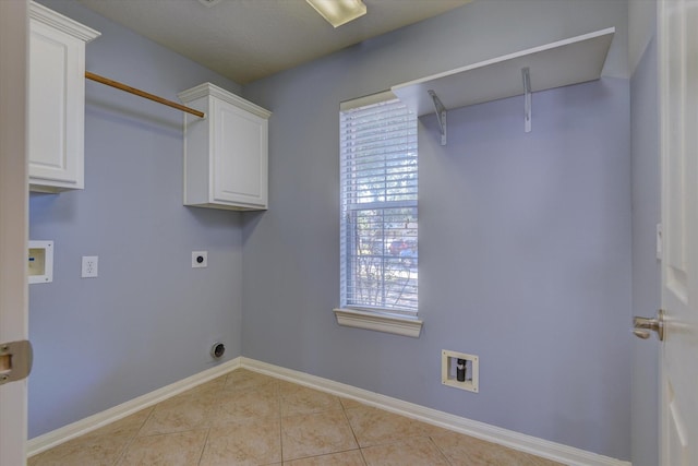 17519 Bighorn River Ln, Humble, TX 77346 - laundry room featuring light tile patterned flooring, baseboards, hookup for a washing machine, cabinet space, and hookup for an electric dryer