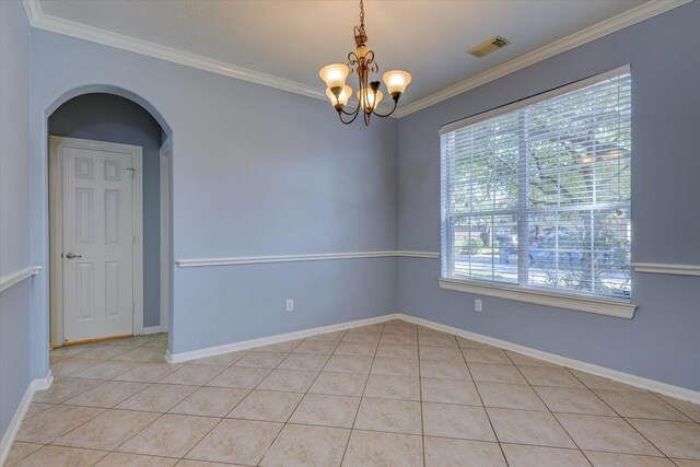17519 Bighorn River Ln, Humble, TX 77346 - empty room featuring a chandelier, light tile patterned floors, crown molding, baseboards, and arched walkways