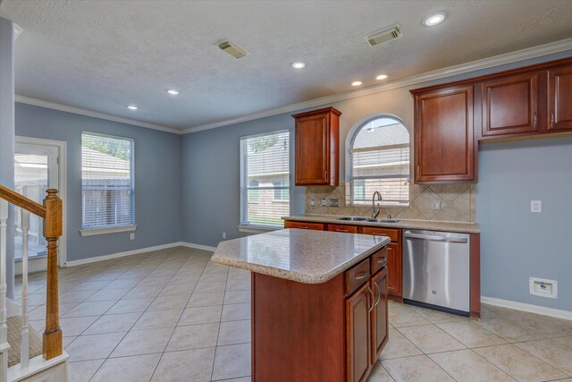 17519 Bighorn River Ln, Humble, TX 77346 - kitchen with stainless steel dishwasher, a sink, crown molding, tasteful backsplash, and a kitchen island