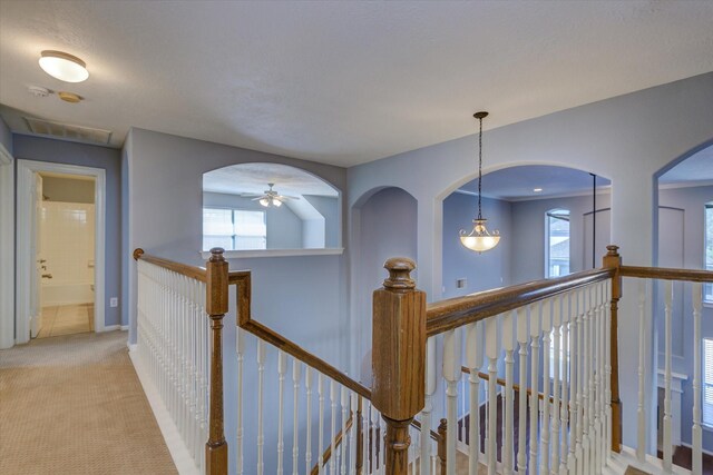 17519 Bighorn River Ln, Humble, TX 77346 - hall featuring an upstairs landing, light carpet, healthy amount of natural light, and baseboards